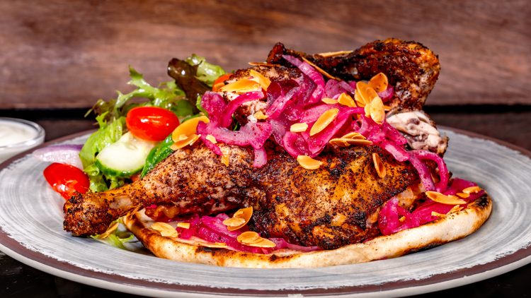 Chicken musakhan (Paradise Garden Grill at Disney California Adventure Park in Anaheim, Calif.): Roasted spiced half chicken and sumac stewed onions on flatbread with a Mediterranean salad and garlic yogurt dipping sauce