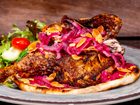Chicken musakhan (Paradise Garden Grill at Disney California Adventure Park in Anaheim, Calif.): Roasted spiced half chicken and sumac stewed onions on flatbread with a Mediterranean salad and garlic yogurt dipping sauce